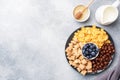 Set of dry cereal flakes for Breakfast with milk and berries. Healthy natural food. copy space Grey concrete background Royalty Free Stock Photo