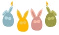 A set of Easter candles in the form of simplified rabbits, hares. Colored hares in the shape of an egg with wax candle