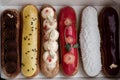 Set of eclairs. Amazing fresh colorful home-made eclairs close up on the white background. Royalty Free Stock Photo