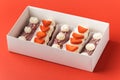 Set of eclairs with chocolate glaze, decorated with strawberries and whipped cream cheese topping. Traditional french dessert in a Royalty Free Stock Photo