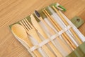 Set of Eco friendly bamboo cutlery on wood background. Sustainable lifestyle. Plastic free concept. Close-up, top view