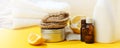 Set of eco-friendly natural cleaning products on yellow kitchen table: soda, essential oils, cellulose sponge, rags, lemon, soap,