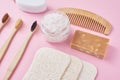 Set of eco friendly personal hygiene objects on a pink background. Bamboo toothbrush, wooden comb, sponge, soap and sea salt, top Royalty Free Stock Photo