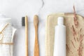 Set of eco-friendly toothbrushes, toothpaste and cotton towel on marble background.