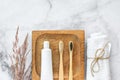 Set of eco-friendly toothbrushes, toothpaste and cotton towel on marble background. Dental and healthcare concept. Royalty Free Stock Photo