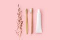 Set of eco-friendly toothbrushes, toothpaste and other tools on pink background. Dental and healthcare concept. Royalty Free Stock Photo