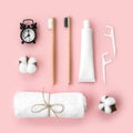 Set of eco-friendly toothbrushes, toothpaste and other tools on pink background.