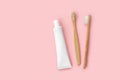 Set of eco-friendly toothbrushes and toothpaste on pink background. Royalty Free Stock Photo