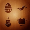 Set Egg in hot pot, Cracked egg, Burning candle and Peace dove with olive branch on wooden background Royalty Free Stock Photo