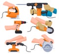 A set of electric tools in the hands of working masters. Tools for repair and construction of premises and various Royalty Free Stock Photo