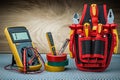 Set of electrical tools on wood background