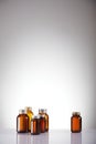 Set of empty brown glass medicine bottles. On grey background. Royalty Free Stock Photo