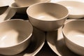 Set of empty and clean ceramic bowls and plates with simple round and curved shapes Royalty Free Stock Photo