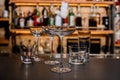 Set of empty crystal clean glasses on dark bar counter. Royalty Free Stock Photo