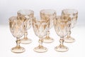 Set of empty gold crystal glasses isolated on white background