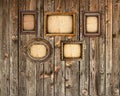 Set of empty picture frames on wooden wall Royalty Free Stock Photo