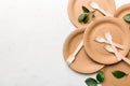 set of empty reusable disposable eco-friendly plates, cups, utensils on light white colored table background. top view Royalty Free Stock Photo