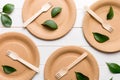 set of empty reusable disposable eco-friendly plates, cups, utensils on light white colored table background. top view Royalty Free Stock Photo