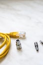 Set engineering yellow internet cable rj45 and bits replaceable screwdrivers stand on a light background