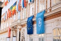 Set of European Union flag and United Nations flags hanging on building in Vienna, Austria