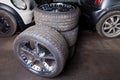 A set of expensive stylish winter tires for a German car with chrome wheels in the garage against the background of cars stored in