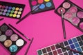 Set of eye shadow . Make up products on pink background with empty space at center. Makeup brushes and colorful Royalty Free Stock Photo