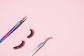 Set for eyelash extension on a pink background. Concept beauty beauty. False eyelashes and tweezers Royalty Free Stock Photo