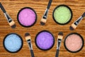Set of 5 eyeshadows and brushes over wooden texture close-up Royalty Free Stock Photo