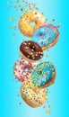 Set of falling delicious donuts on blue background