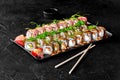 Set for family dinner with delicious Japanese sushi rolls Royalty Free Stock Photo