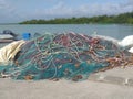 Set of fishing nets and ropes of different sizes and colors on a pier