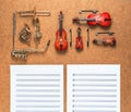Set of five golden brass wind and four string musical orchestra instruments and sheet music lying near it. Music concept. Royalty Free Stock Photo