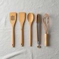 A set of five kitchen utensils displayed vertically on a light gray fabric background. The Royalty Free Stock Photo