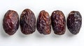 Set of five semi-dry dates, or date palm fruits isolated on white background. Royalty Free Stock Photo