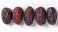 Set of five semi-dry dates, or date palm fruits isolated on white background. Royalty Free Stock Photo