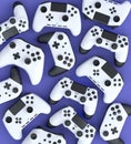 Set of flying gamer joysticks or gamepads on violet background