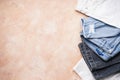 Set of folded jeans on a beige background, place for text, flat lay