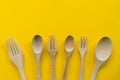 Set of fork,spoon and dish wood with yellow background Royalty Free Stock Photo
