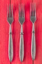 A set of forks on a red wooden surface. Top view Royalty Free Stock Photo