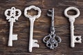 Set of four antique keys, one being different and upside down Royalty Free Stock Photo