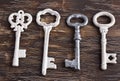 Set of four antique keys, one being different Royalty Free Stock Photo