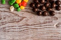 set four bowls of colorful bright round sweet candies yellow blue blue white on a vertical board background Royalty Free Stock Photo