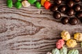 set four bowls of colorful bright round sweet candies yellow blue blue white on a vertical board background Royalty Free Stock Photo