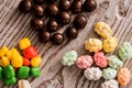 set four bowls of colorful bright round sweet candies yellow blue blue white on a vertical board background Royalty Free Stock Photo