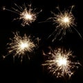 Set of four bright burning sparklers on a black background Royalty Free Stock Photo