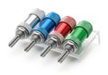 Set of four colored metal drill bits displayed on a clear plastic holder Royalty Free Stock Photo