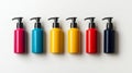 A set of four differently colored shampoo bottles, all empty and featuring pump tops, displayed on a white surface Royalty Free Stock Photo