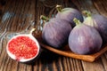 A set of four figs one has been sliced isolated on wooden background