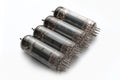 A set of four guitar amplifier power tubes on white background