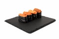 Set of four gunkan sushi rolls on black ceramic table setting plate Royalty Free Stock Photo